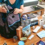 A woman packs a go-bag emergency kit in case of fire.