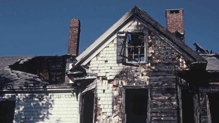 A home that has been charred and burned by a recent fire.